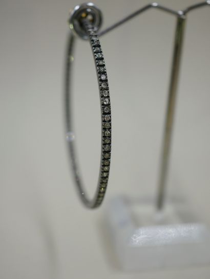 null 
Pair of large 14k yellow and blackened gold hoop earrings, paved with diamonds....
