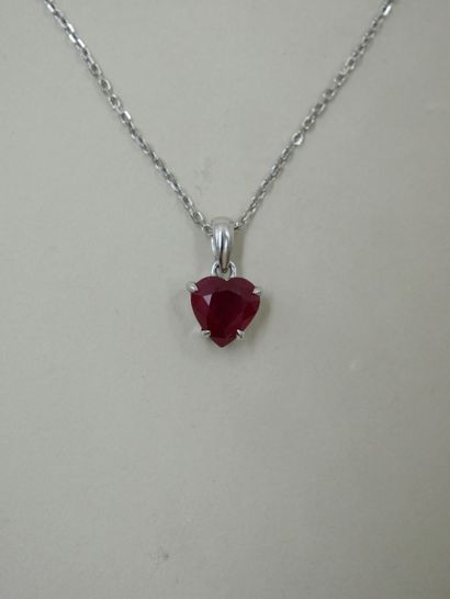 null 18k white gold necklace holding a pendant set with a heart-shaped ruby probably...