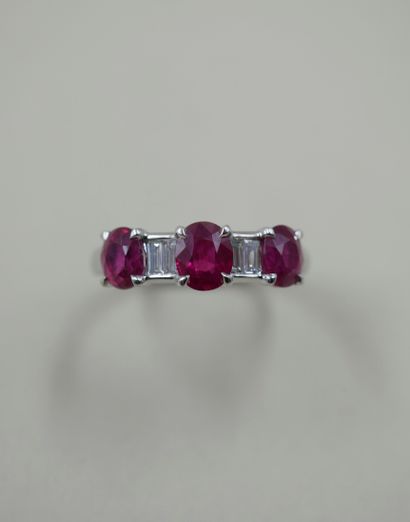 null 18k white gold ring set with three oval rubies weighing a total of about 2.10cts...