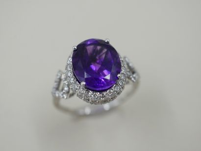 null White gold ring set with a 5 cts amethyst surrounded by two lines of diamonds...