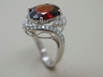 null 18k white gold ring set with a 5cts spessartite garnet in an openwork setting...