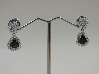null Pair of 18k white gold earrings set with pear-cut sapphires in a diamond setting...