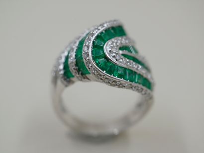 null Ring in 18k white gold made of lines of calibrated emeralds and lines of diamonds...