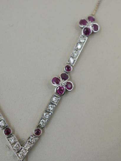 null 18k white gold necklace holding four flowers, the petals adorned with round...
