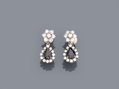 null Pair of 18k white gold earrings set with pear-cut sapphires in a diamond setting...