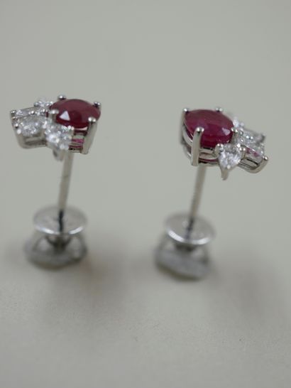 null Pair of 18k white gold earrings set with a ruby weighing approximately 0.70cts...