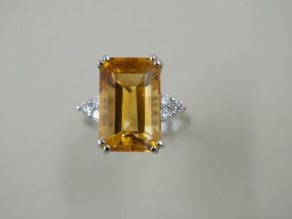 null 18k white gold ring set with a rectangular emerald cut citrine weighing approximately...