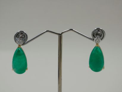 null Pair of 18k yellow gold and platinum earrings each bearing a pear-cut emerald...