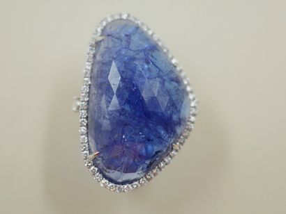 null 18k white gold ring set with a large facetted tanzanite of 50cts circled by...