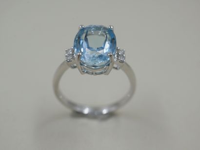 null An 18k white gold ring set with an oval blue topaz weighing approximately 4.50...