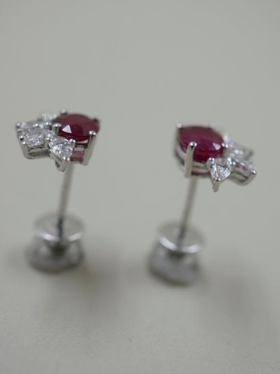 null Pair of 18k white gold earrings set with a ruby weighing approximately 0.70cts...