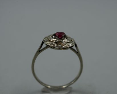 null 18k white gold ring with a red stone in a double circular braided setting paved...