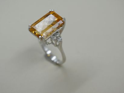 null 18k white gold ring set with a rectangular emerald cut citrine weighing approximately...