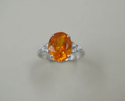 18k white gold ring set with an oval spessartite...