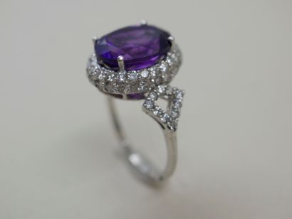 null White gold ring set with a 5 cts amethyst surrounded by two lines of diamonds...