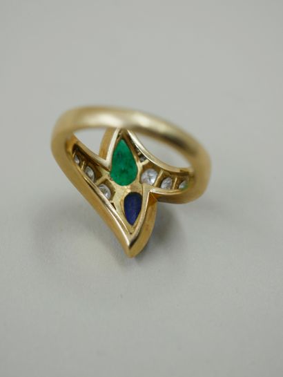 null An 18k yellow gold "You and I" ring set with a sapphire and an emerald each...
