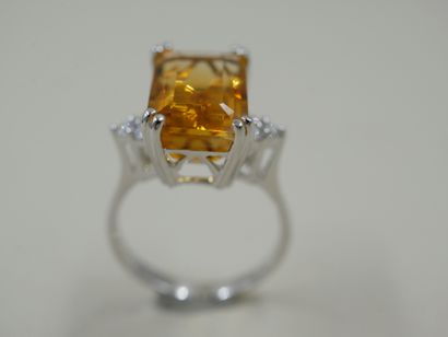 null 18k white gold ring set with a rectangular emerald cut citrine weighing about...