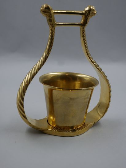 null HERMES - Pencil pot in gilded metal enclosed in a twisted lyre motif surmounted...