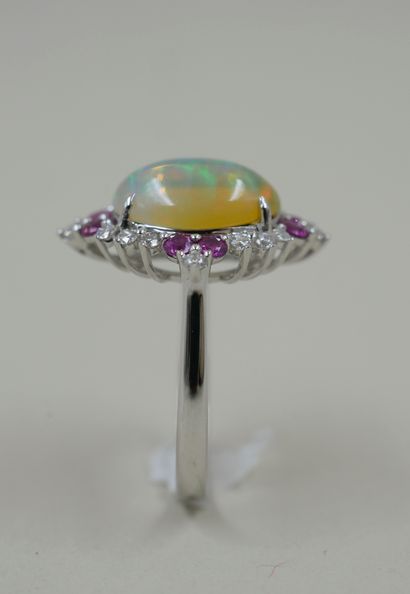 null 18k white gold ring set with a cabochon opal weighing approximately 2.20 cts...