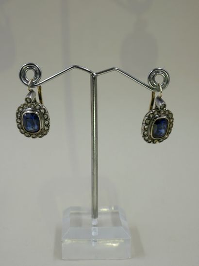 A pair of silver and 18k yellow gold earrings...