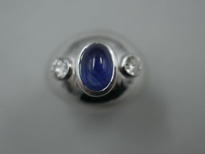 null Dome ring in 18k white gold set with an oval sapphire cabochon with two diamonds...
