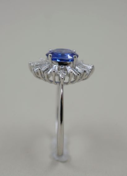 null 18k white gold skirt ring set with an oval sapphire weighing approximately 1.20cts...