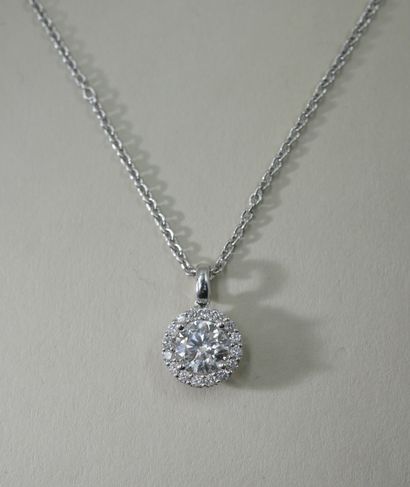 null An 18k white gold necklace holding a round diamond weighing approximately 1ct...