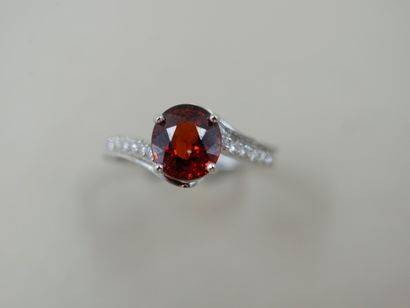 null Tourbillon ring in 18k white gold set with an oval spessartite garnet of about...