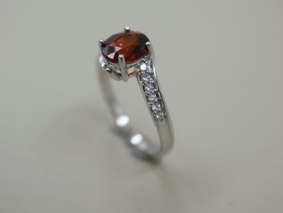 null Tourbillon ring in 18k white gold set with an oval spessartite garnet of about...