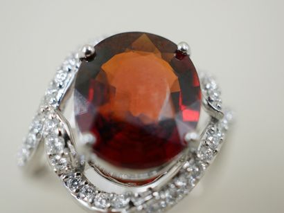null 18k white gold ring set with a 5cts spessartite garnet in an openwork setting...
