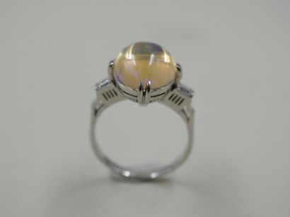 null NOT SOLD - Ring in 18k white gold with a cabochon opal and baguette diamonds...