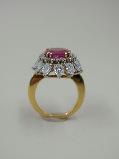 null 18k yellow gold and platinum flower ring set with an oval unheated Burmese ruby...