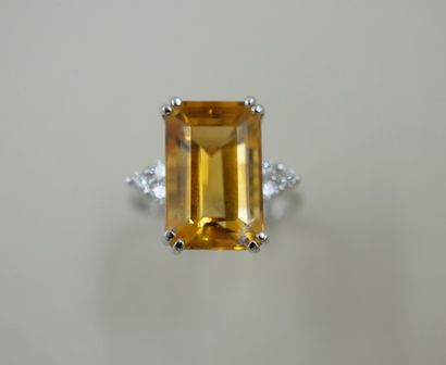 null 18k white gold ring set with a rectangular emerald cut citrine weighing about...