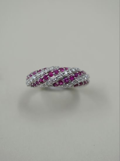 null Band ring in 18k white gold paved with alternating lines of rubies and diamonds...