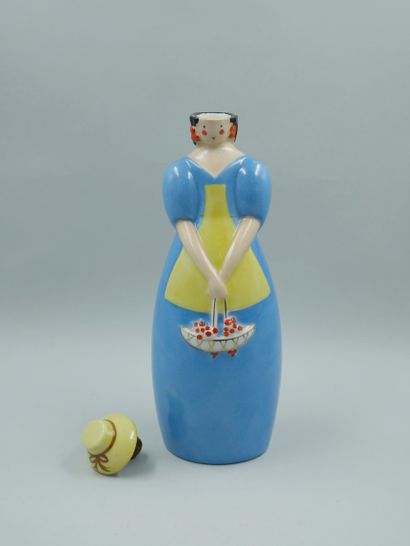 null 
ROBJ. Flacon à liqueur en porcelaine émaillée représentant une femme au panier...