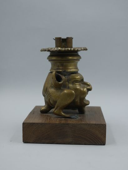 null Gilt bronze candlestick representing a chimera with a grimacing man's face,...