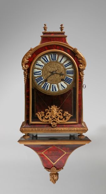  Wall clock and its console in tortoiseshell veneer, the dial with Roman numerals...