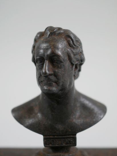 null A patinated bronze paperweight representing a bust of Goethe, on a white marble...