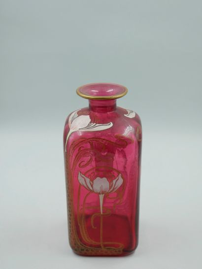  Red glass bottle with white and gold enamelled flowers. Signed under the base. Art...
