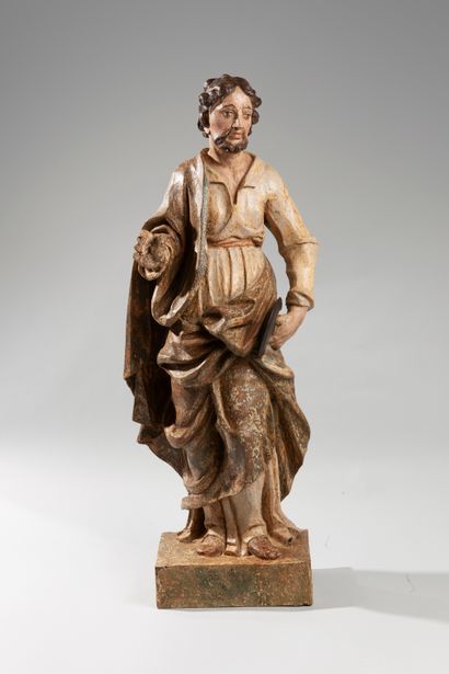  Polychrome wooden sculpture representing Saint Barthelemy. The saint draped in a...