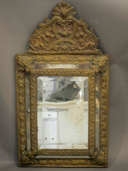 null A brass mirror with a leaf, interlacing and shell motif. Regency style. 19th...