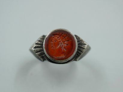 A low-title silver ring set with a carnelian...