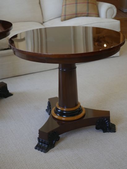 null A pair of veneered pedestal tables, the central shaft trimmed with a light wood...