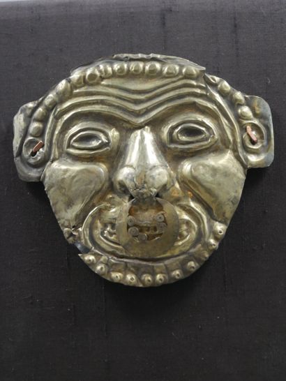 null Votive mask symbolizing old age and beyond eternal wisdom. Gold leaf pierced,...