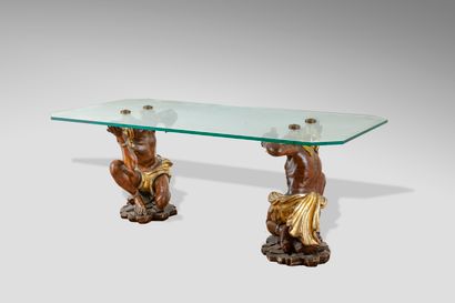 null Coffee table with rectangular glass top, the base composed of two carved wood...