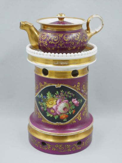 null A polychrome enamelled porcelain teapot decorated with flowers in cartouches...