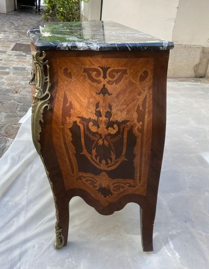 null A curved chest of drawers made of inlaid wood with floral scrolls, opening with...