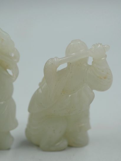 null Two carved jade netsuke representing children playing. Height 4 and 5cm.