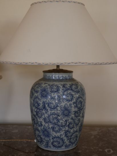 null A blue and white porcelain lamp base decorated with lotus flowers in foliage...