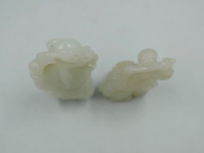 null Two carved jade netsuke representing children playing. Height 4 and 5cm.